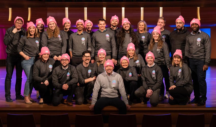 Photo of students and staff of the Taylor Centre for the Performing Arts with their Centre the Arts sweatshirts and toques.