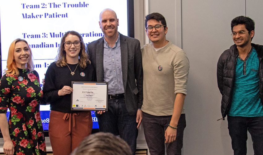 Team Kistoonan pose with a certificate of achievement