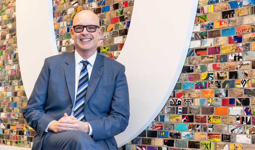 Tim Rahilly, PhD, poses for a photo in the Riddell Library and Learning Centre.