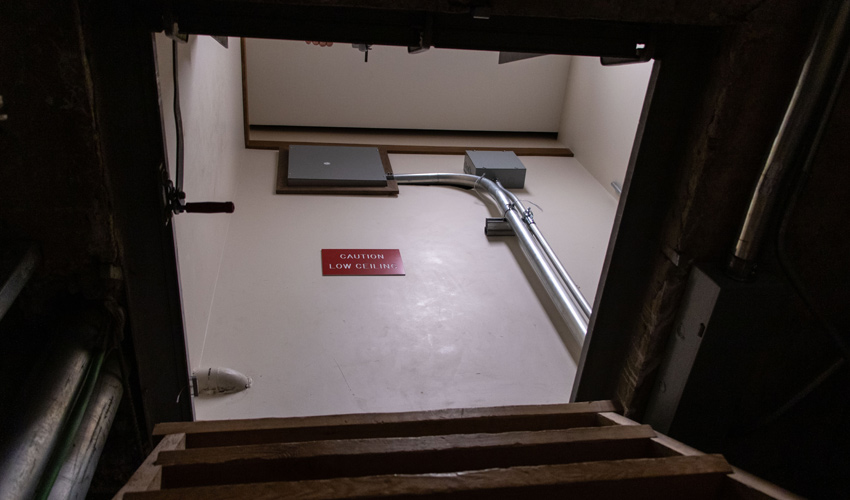 The tunnel ends where E-Wing ends. A stairway climbs up to a hatch, which opens into a closet inside a classroom.