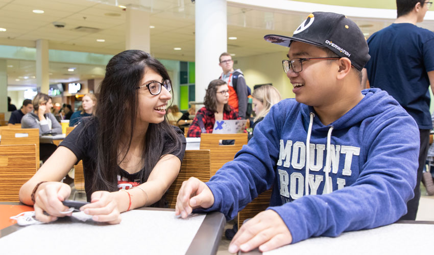 Jessy Aulakh and Jonathan Galang are part of the hubbub in the on-campus food court in Wyckham House.