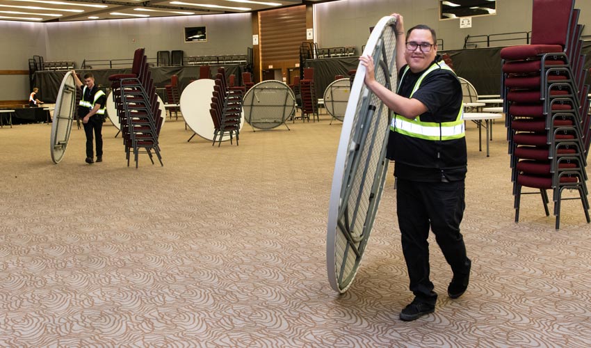 Kyle Poor Eagle moving a table at Grey Eagle Resort & Casino.