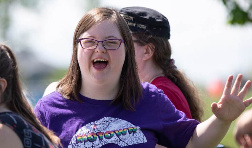 A student smiling and having a good time at Big Bob’s BBQ.