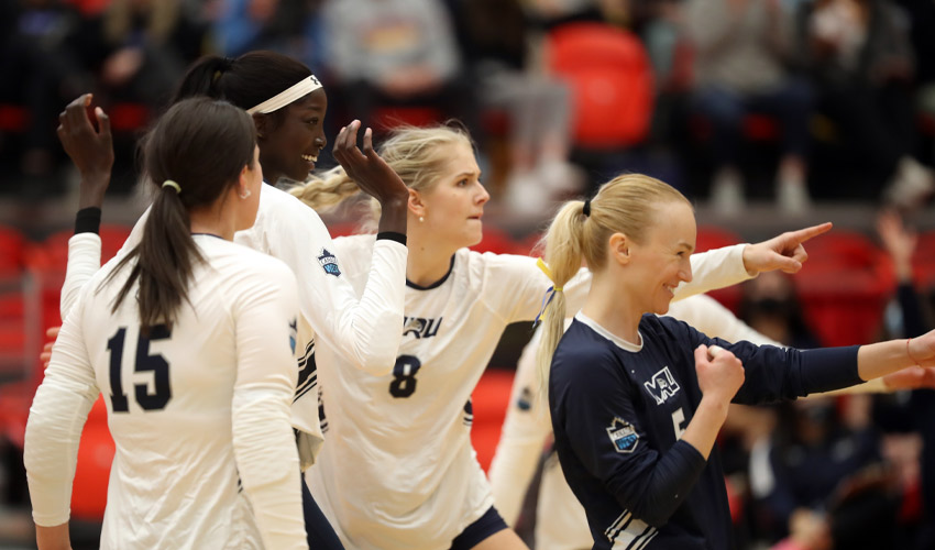 Members of the Cougars Women's volleyball team celebrate.