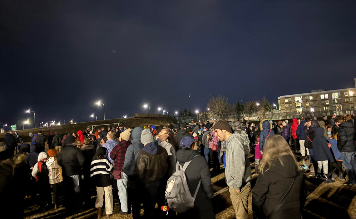 A crowd gathers at MRU’s soccer field to catch a glimpse of rare planetary alignment.
