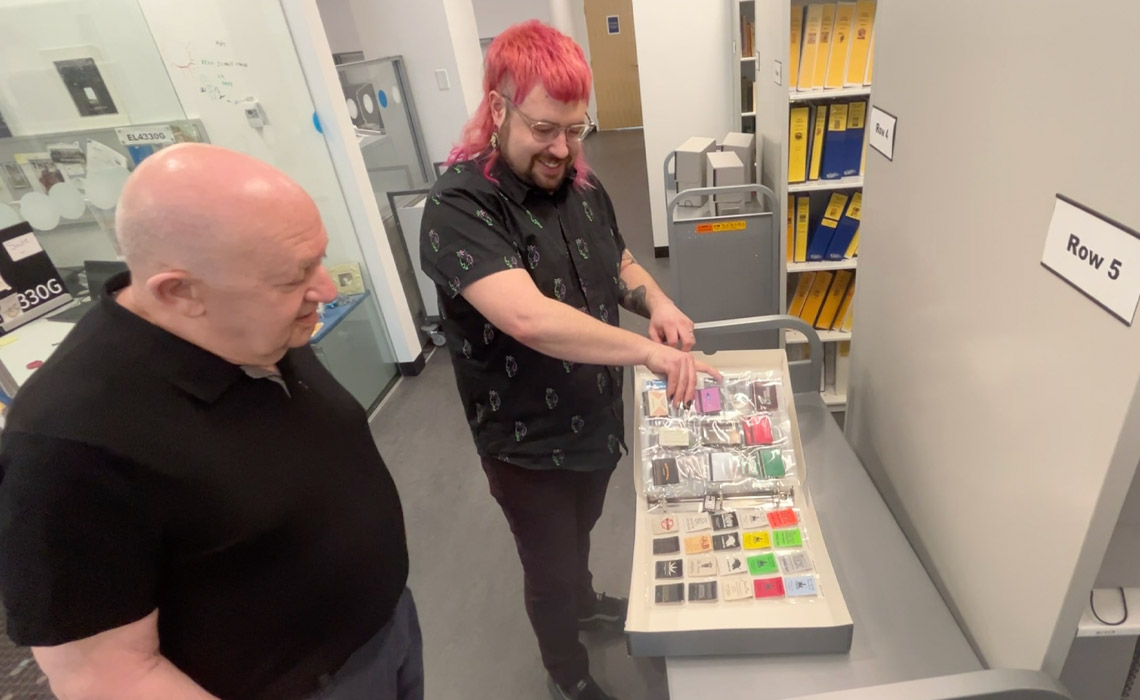 Dr. David Aveline, PhD and Sydney Morrissette browse artifacts from the Aveline-Vazquez LGBTQ+ Library Archive Collection.