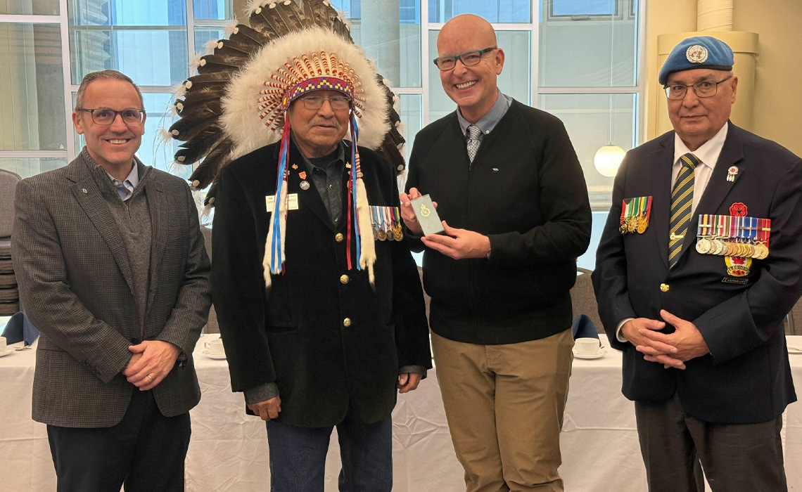 Dr. Chad London, provost and VP Academic; Elder Miiksika’am; Dr. Tim Rahilly, president and vice-chancellor, and Major Bob Crane (Retired).