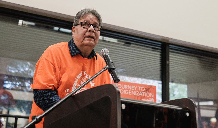 Elder Roy Bear Chief speaking at Mount Royal University on Main Street.
