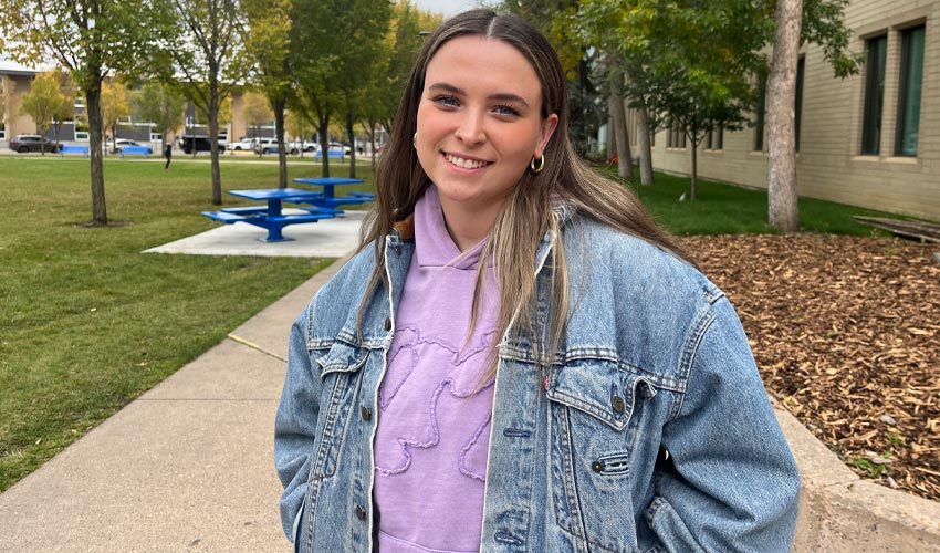 Faith Thomason posing for a photo at Mount Royal University.