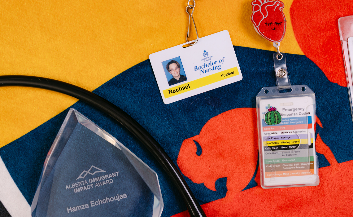 Healthcare mementos including an achievement award for Hamza Echchoujaa, a Bachelor of Nursing student ID for Rachael, and a hospital emergency code card on a colorful background.