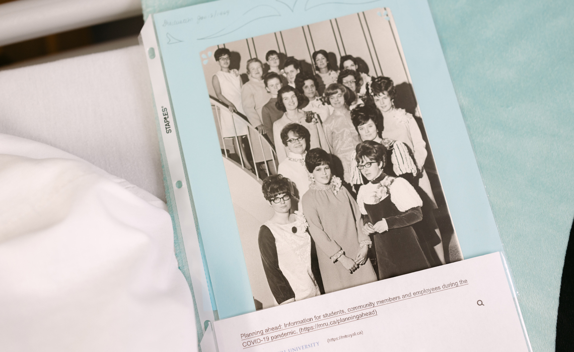 A vintage black-and-white photo of a nursing graduating class tucked into a modern document folder.