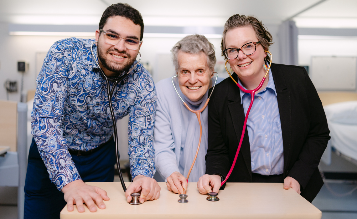 Echchoujaa, Kendrew and Edwards pose with stethoscopes while sharing a laugh.