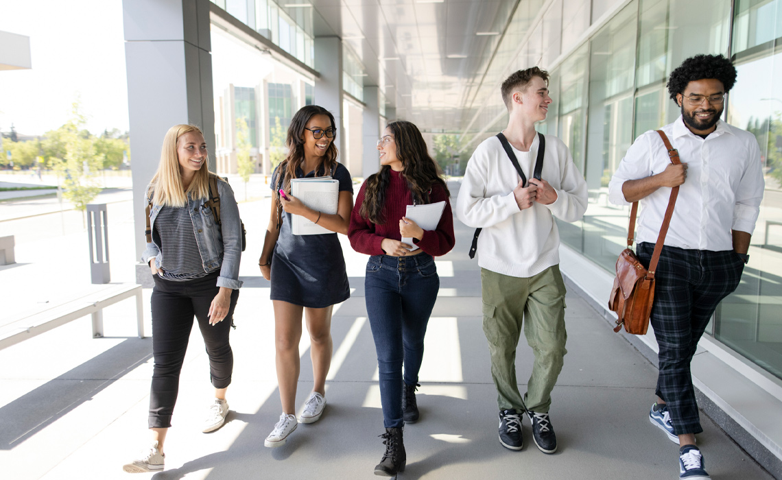 A group of young people walking together, engaged in conversation and enjoying each other's company.