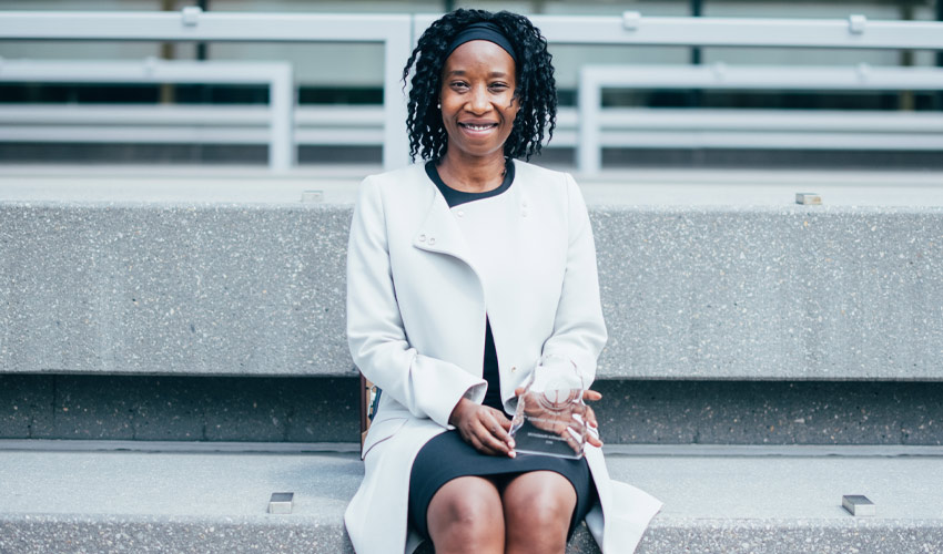 Dr. Jacqueline Musabende poses for a photo outside the Riddell Library & Learning Centre - Calgary.