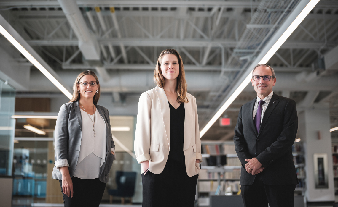 Jody Arndt, PhD; Lisa Taylor, PhD, and Chad London, PhD, pose for a photo in the Riddell Library & Learning Centre.