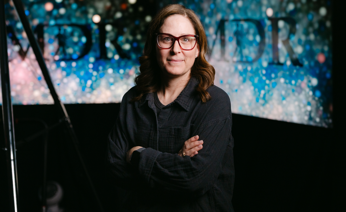 Katherine Bright smiling while standing in a university lab.