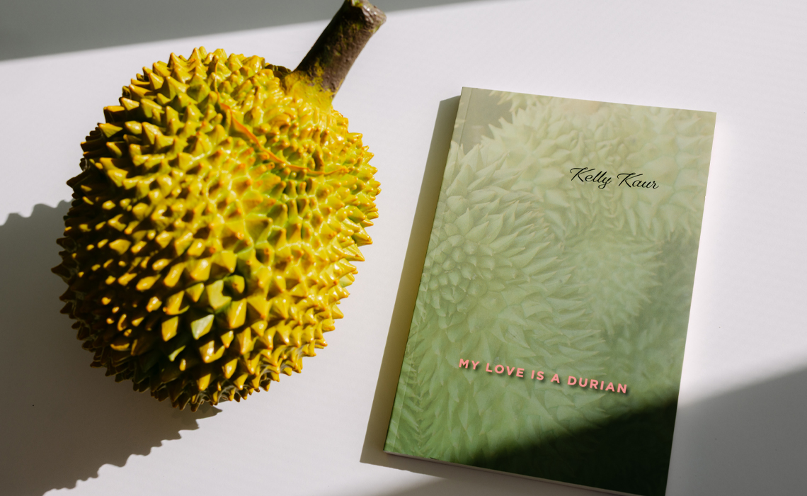 Kelly Kaur’s new book beside a durian fruit