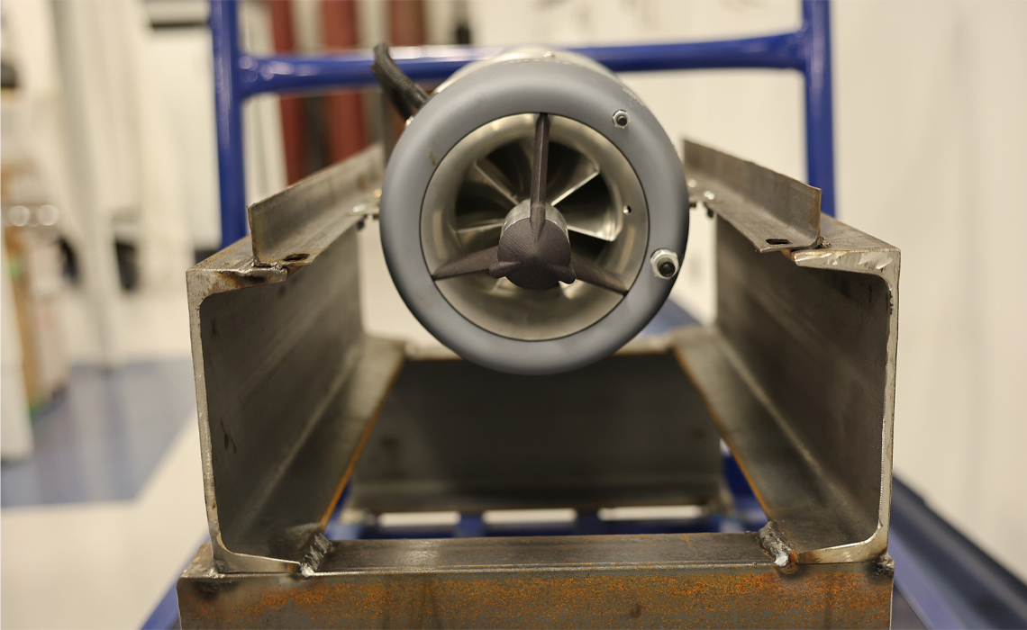 A jet engine mounted on a sturdy metal stand, showcasing its intricate design and engineering features.