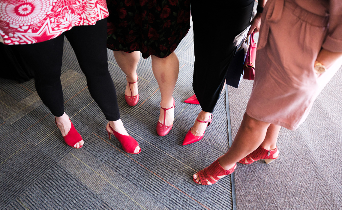 Red shoes worn by midwives captured at the party celebrating 10 years of midwifery graduates on campus.