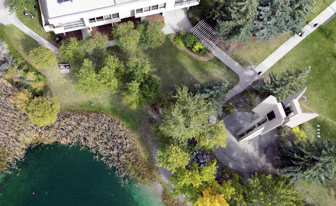 An aerial view of the Kerby Memorial Tower and Charlton Pond at Mount Royal University.
