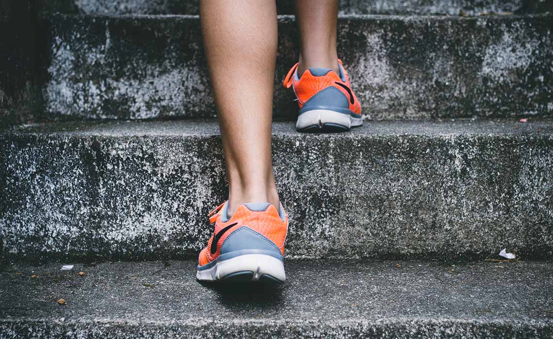 Running shoes walking up stairs.