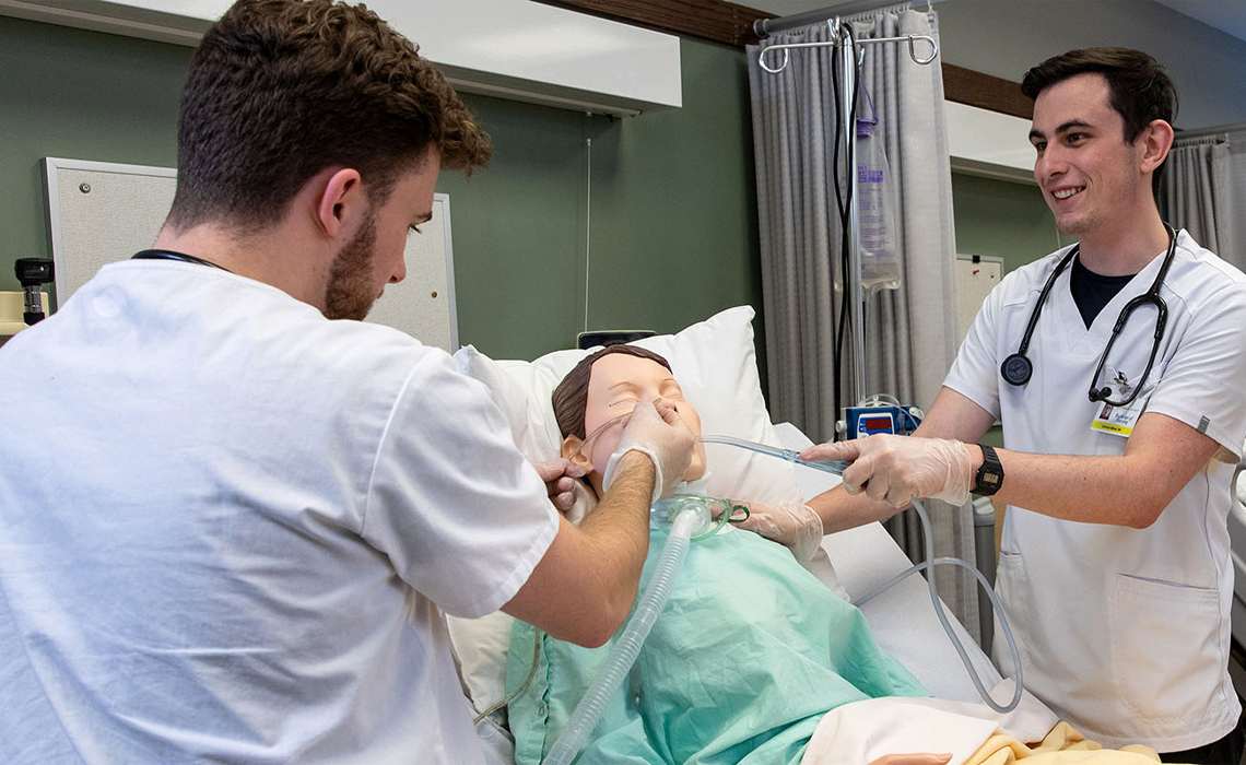 Two students having a discussion in the Health Simulation Learning Centre.