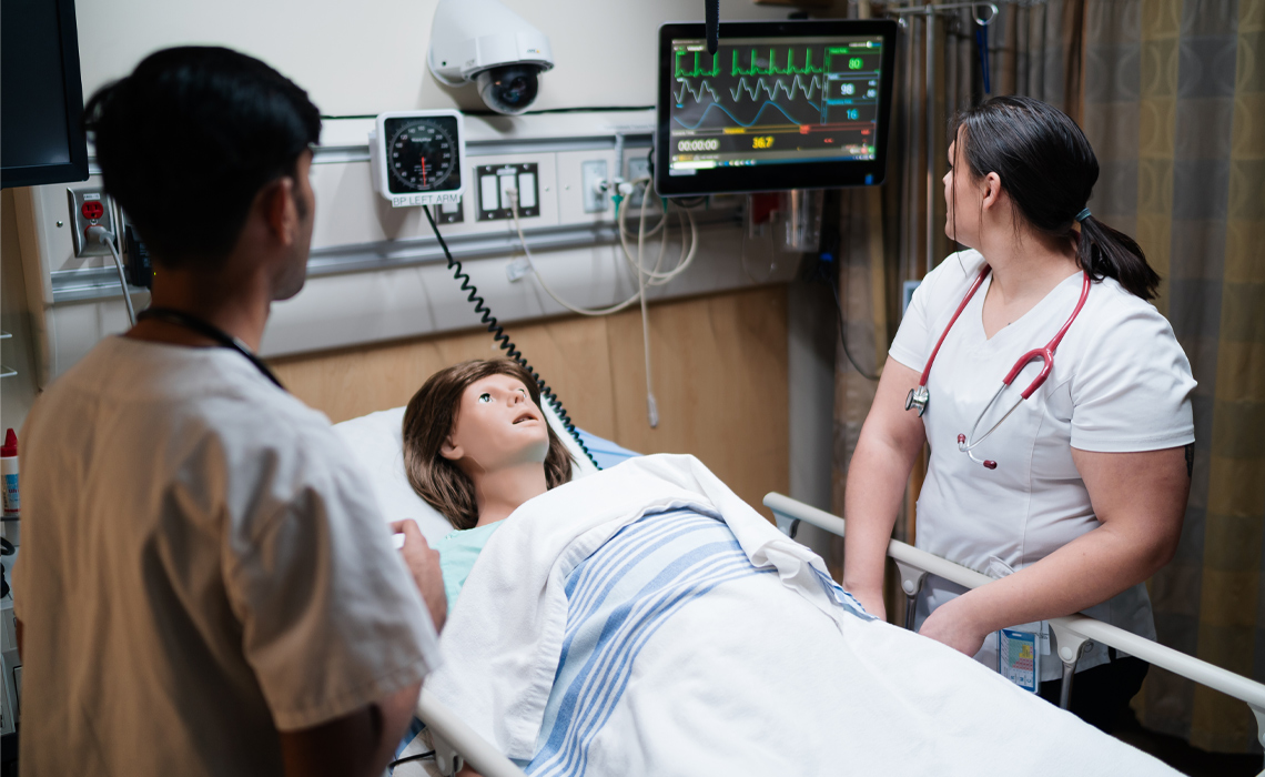 Two students having a discussion in the Health Simulation Learning Centre.
