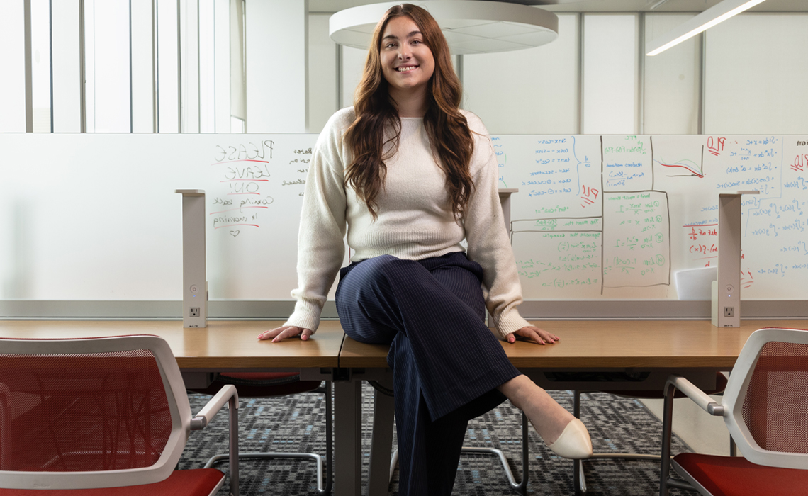 Paige Fell poses for a photo in the Riddell Library & Learning Centre.