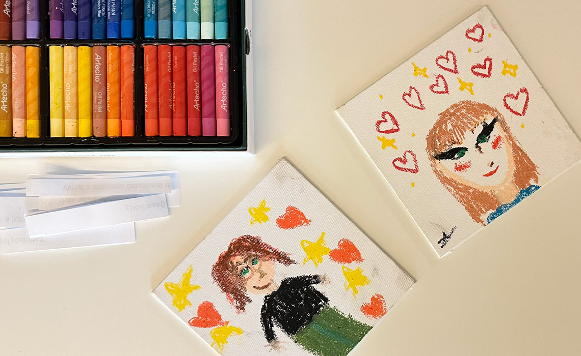 A table featuring a vibrant painting with an assortment of crayons arranged nearby.