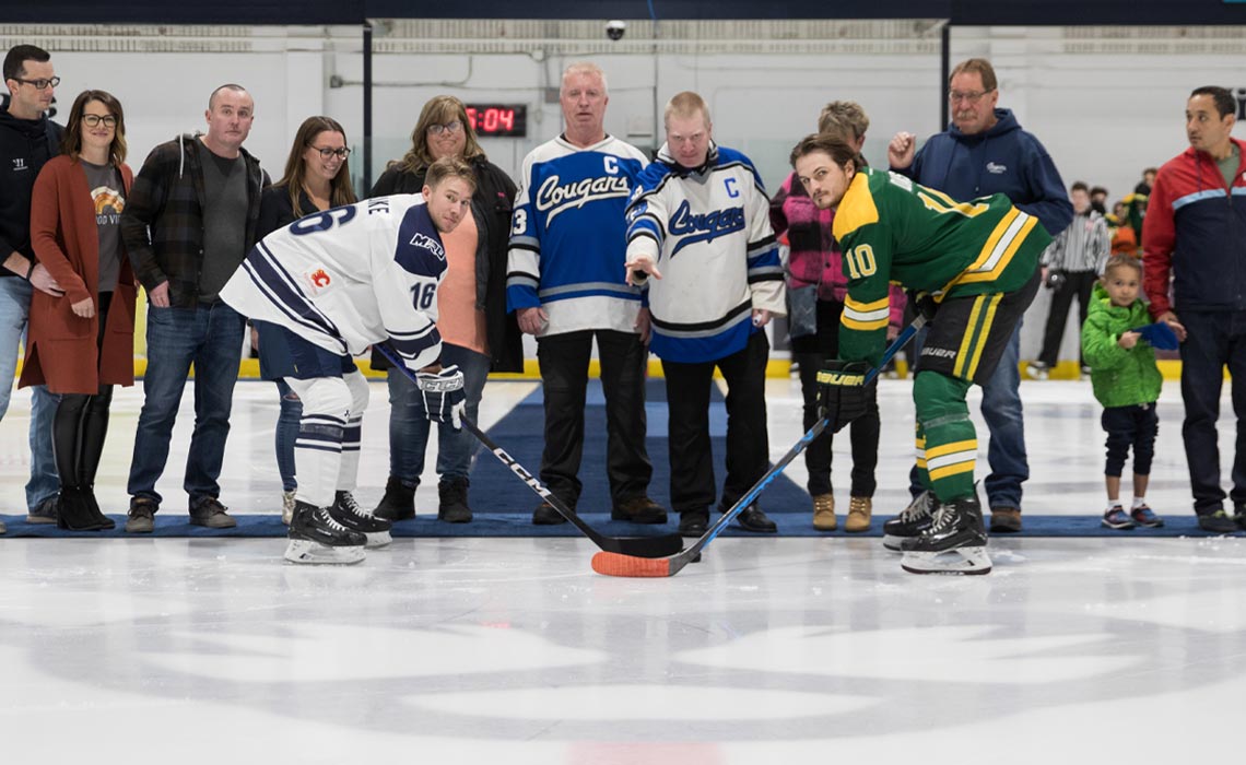 On Sept. 29, the Callaghan family attended the Cougars’ men’s hockey game for a pregame ceremonial puck drop with Connor Blake and others to mark the gift. Photo courtesy Ethan Bomhof.