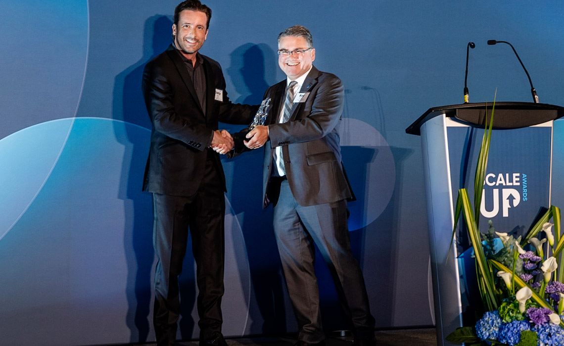 Ray DePaul presenting to ScaleUP Company of the Year ZayZoon's CEO Darcy Tuer.