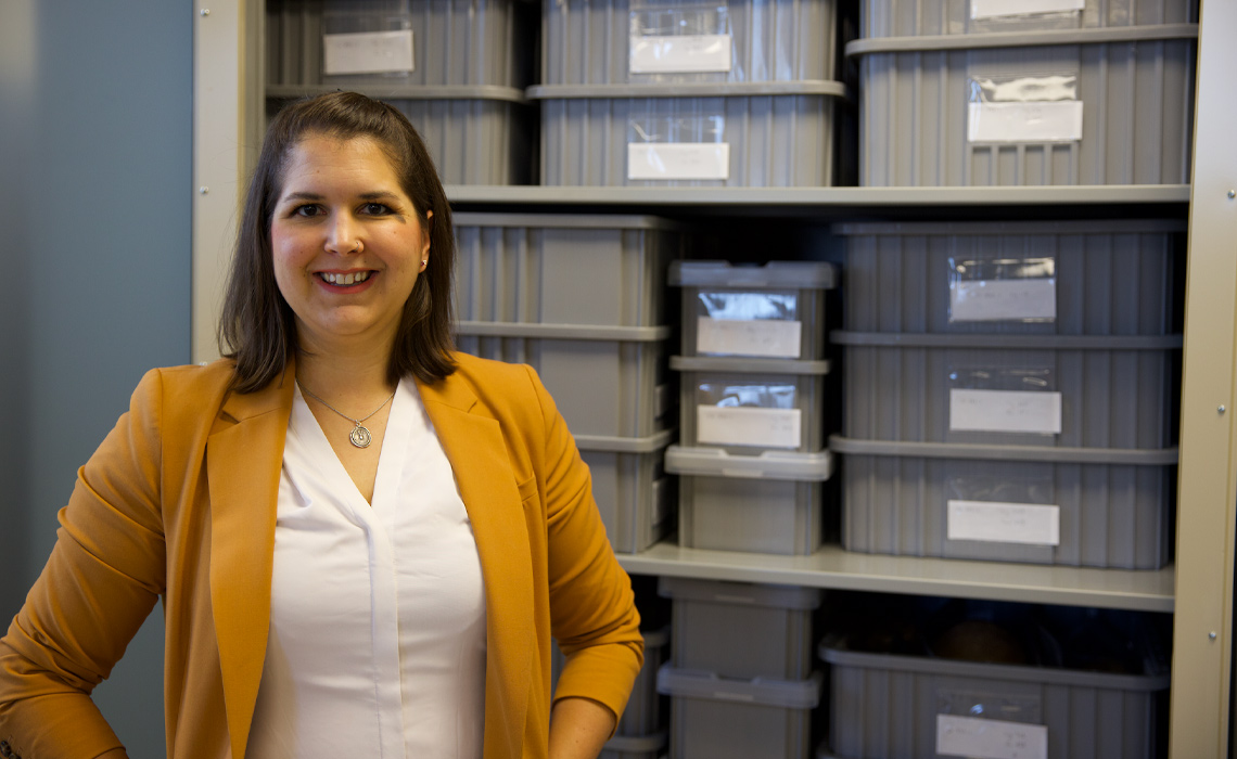 Dr. Rebecca Gilmour PhD in front of the carefully stored and labelled remains.