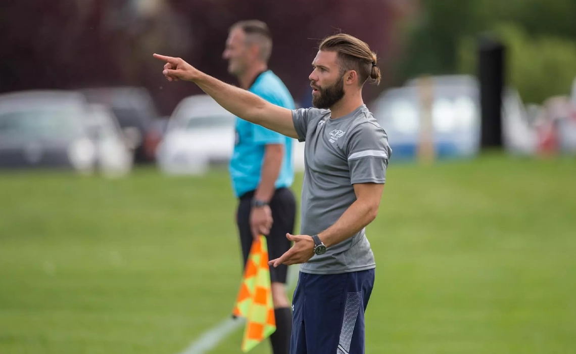 Ryan Gyaki directs his players from the sidelines during a soccer game in Calgary.