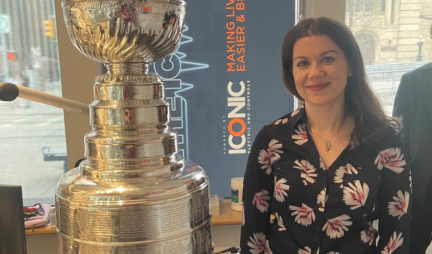 Sandra Prusina standing next to the Stanley Cup.