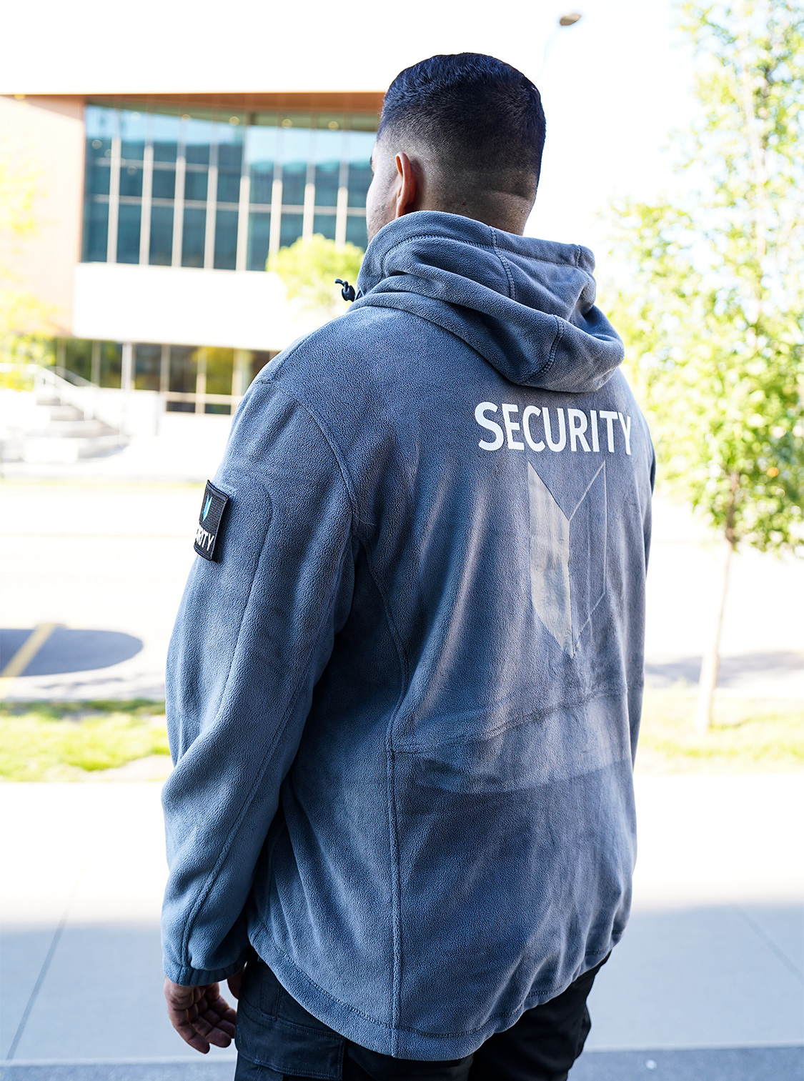 Team uniforms with grey shirts and two-tone jackets, blue exterior with grey interior, designed for visibility and approachability.