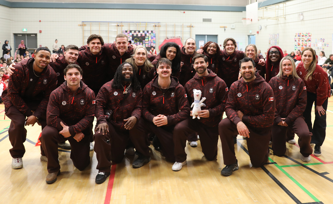 Members of the Canadian Olympic bobsleigh team pose for a photo in a Calgary gym.