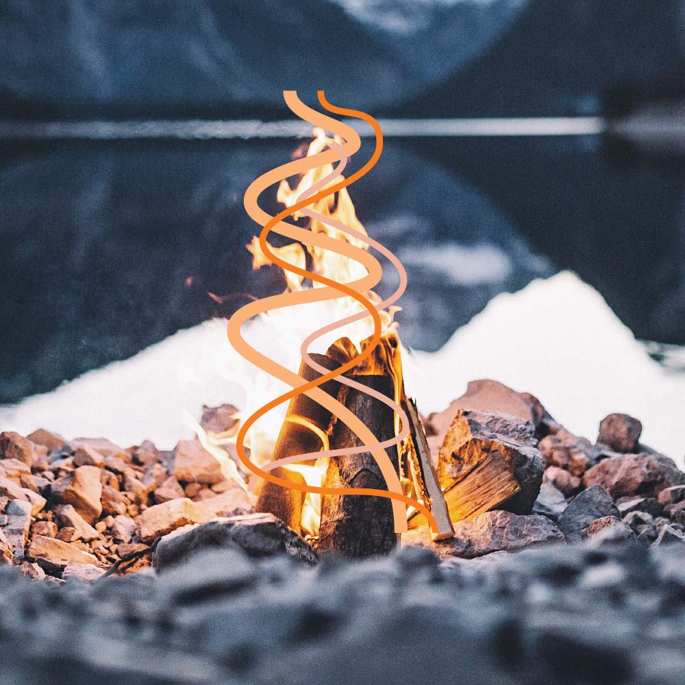 A lodge-shaped fire burning on the rocky shore of a mountain lake. Orange lines in the shape of the flames are drawn over top.