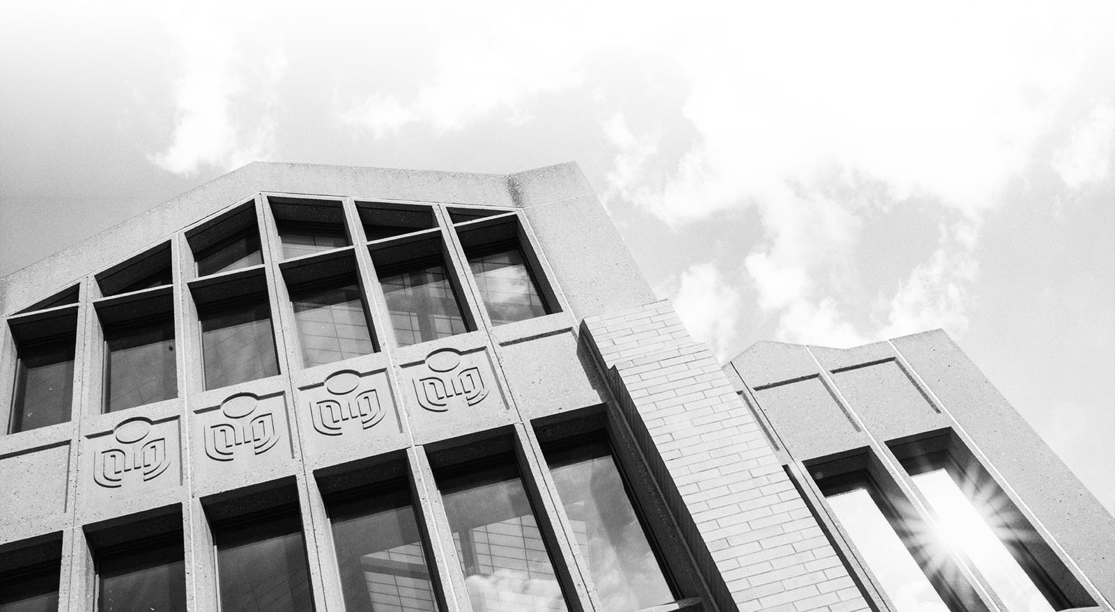 The top portion of the East Gate building. A concrete pointed building with four columns of windows