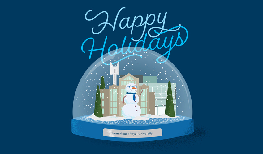 A snow globe with happy holidays written in script.