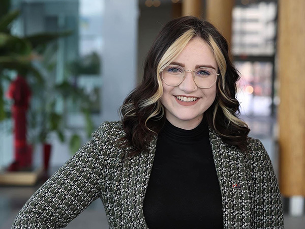 Photo of a smiling Gabrielle Symbalisty in a sharp blazer.