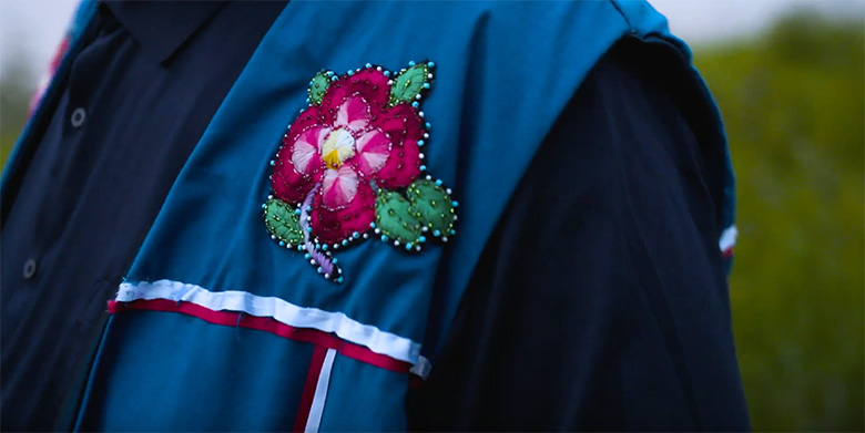 Close up of the embroidered and beaded flow on Samuel Metacat-Yah's jacket.