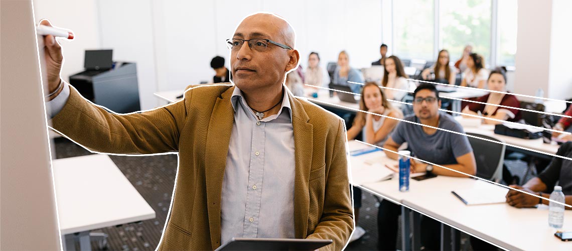 A classroom full of students and a professor writing on a white board.