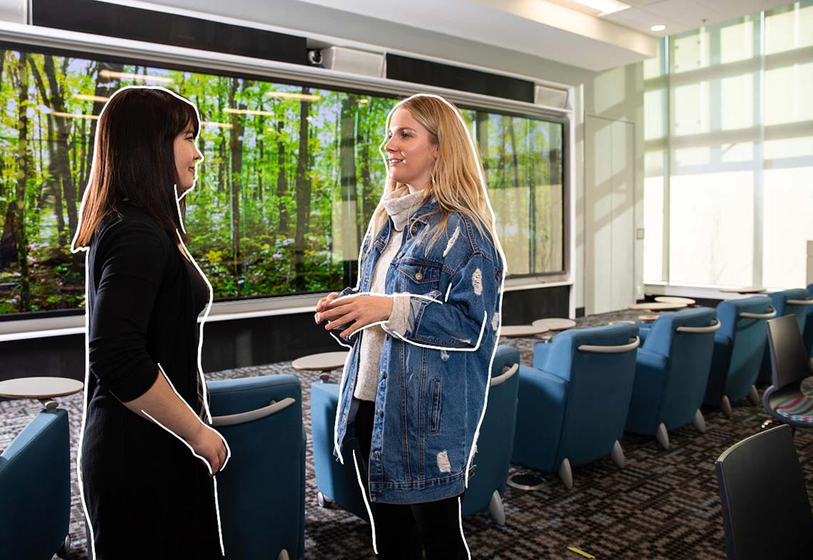 Two students chatting in the Riddell Library and Learning Centre's Ideas Lounge.