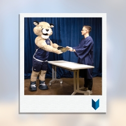 Calvin the Cougar picking up parchment