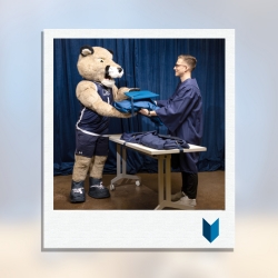 Calvin the Cougar picking up gown