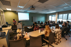 An alum giving a lecture to a classroom of current Mount Royal students.