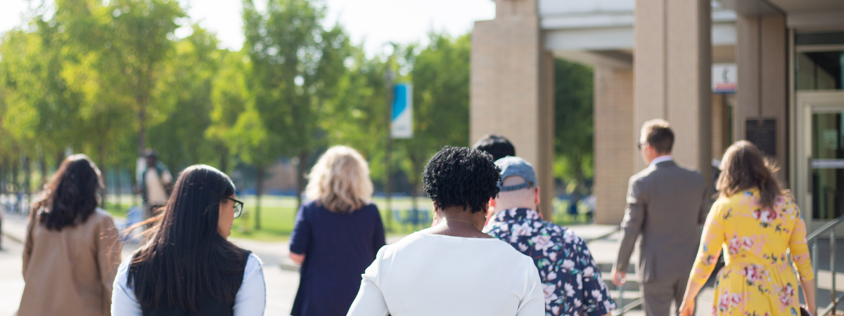 Members of the Alumni Council walking through the East Gate lawn.