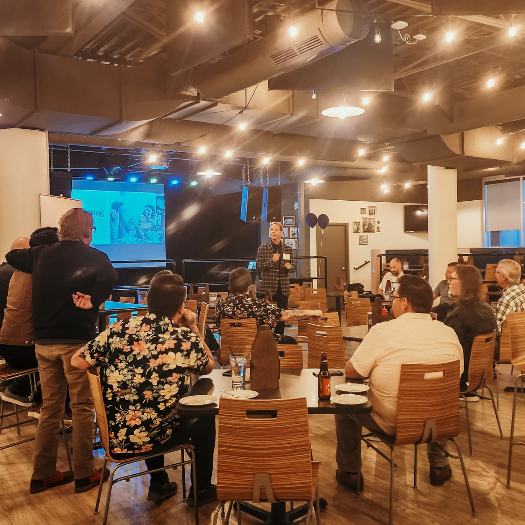 A professional presentation being given to a group of alumni at West Gate Social.