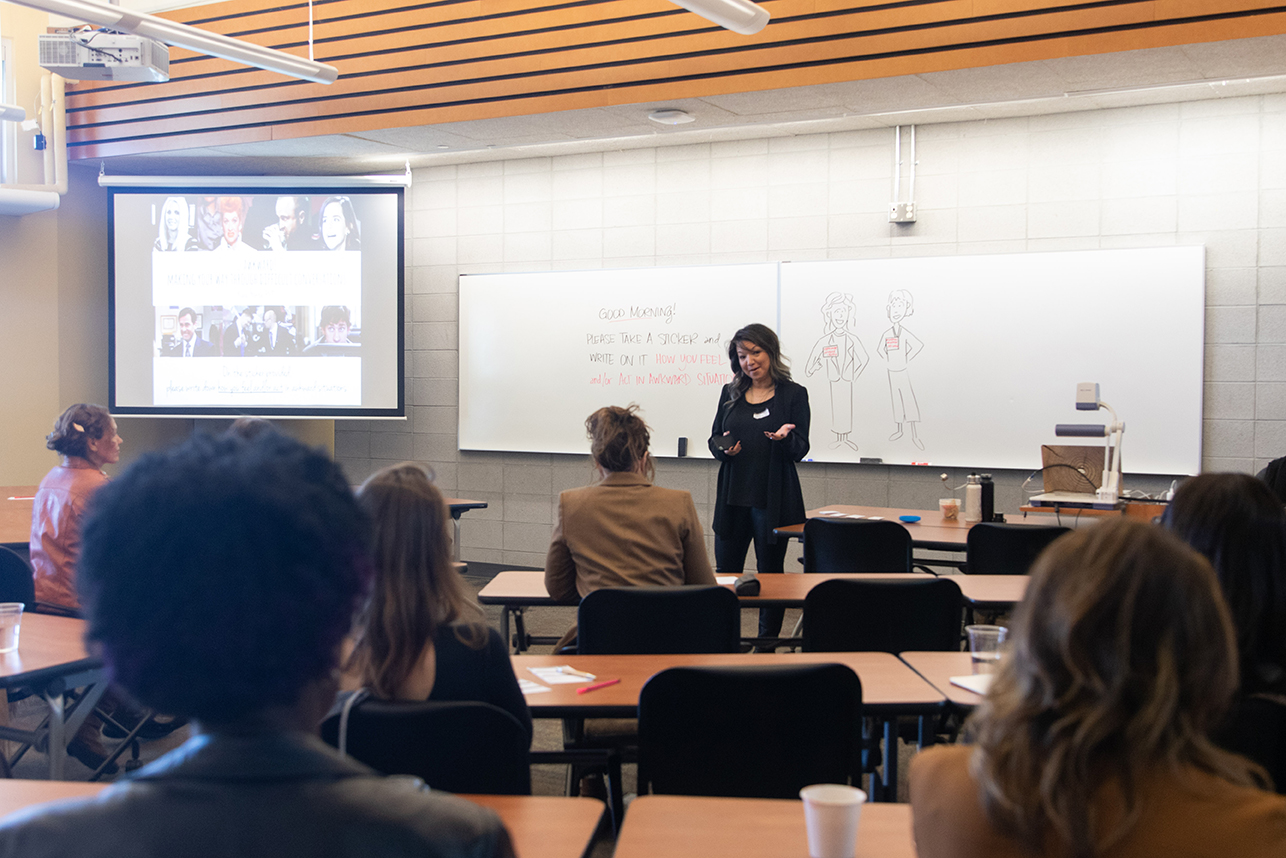 A professional leading an exercise to a group of professionals.
