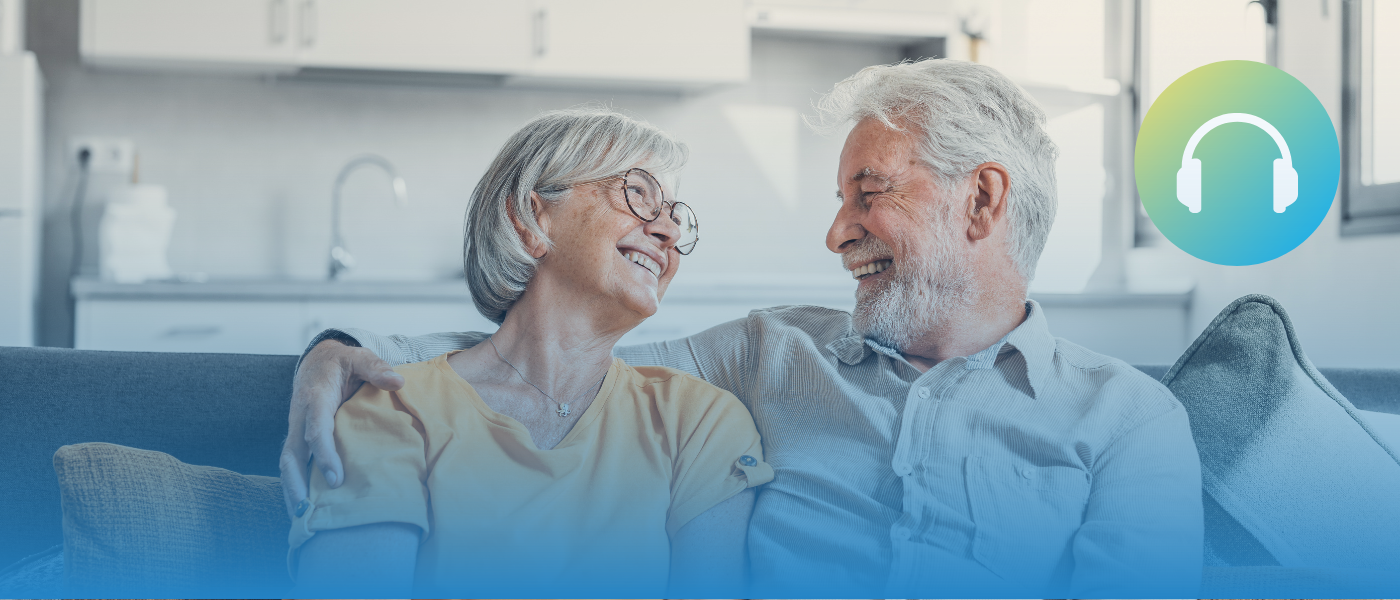 An elderly couple looking at each other lovingly.